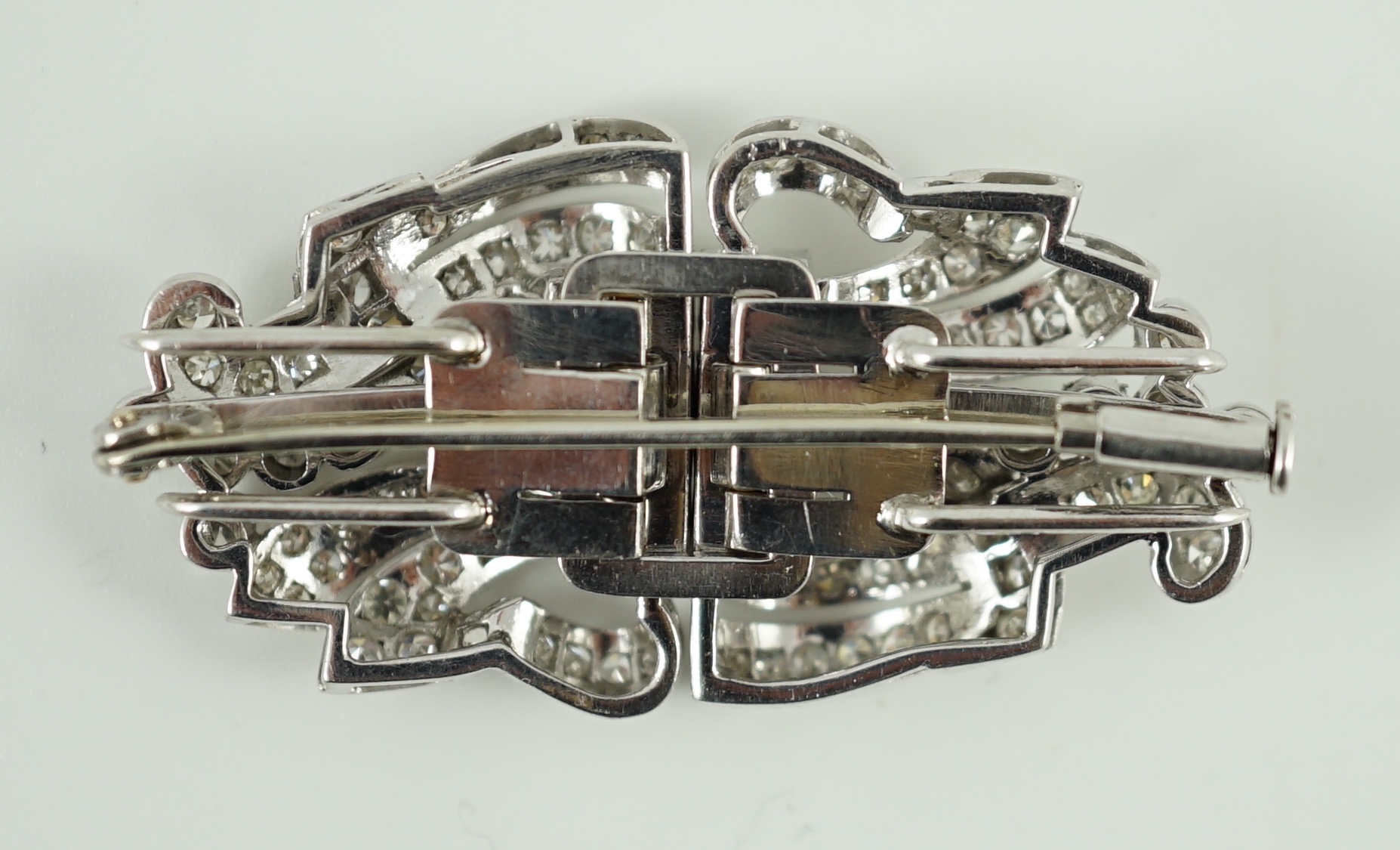 A mid 20th century platinum and diamond cluster double clip brooch
